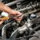 mechanic working car maintenance with soft-focus and over light in the background